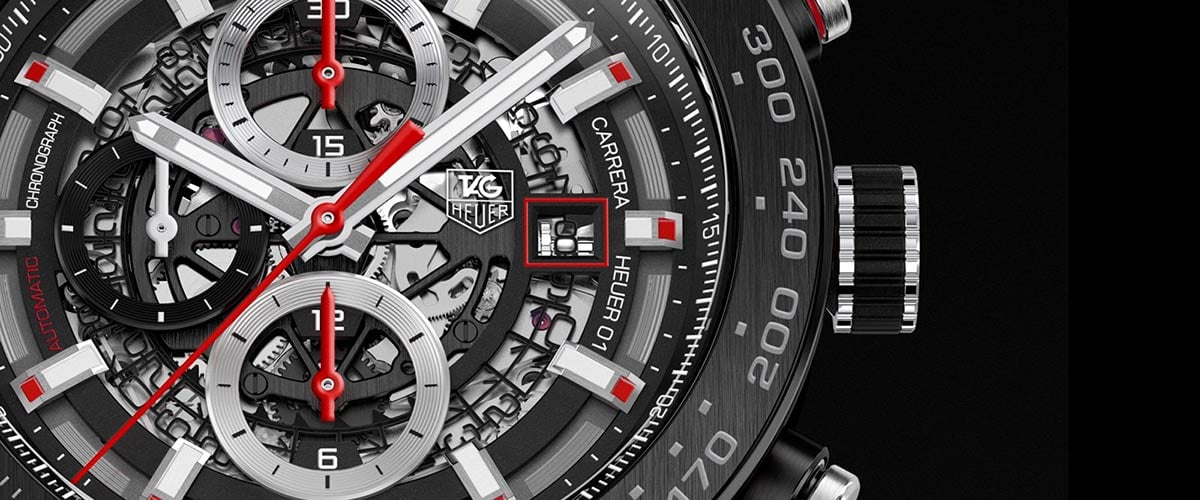 Close-up of a luxury TAG Heuer chronograph watch with detailed dials and red accents
