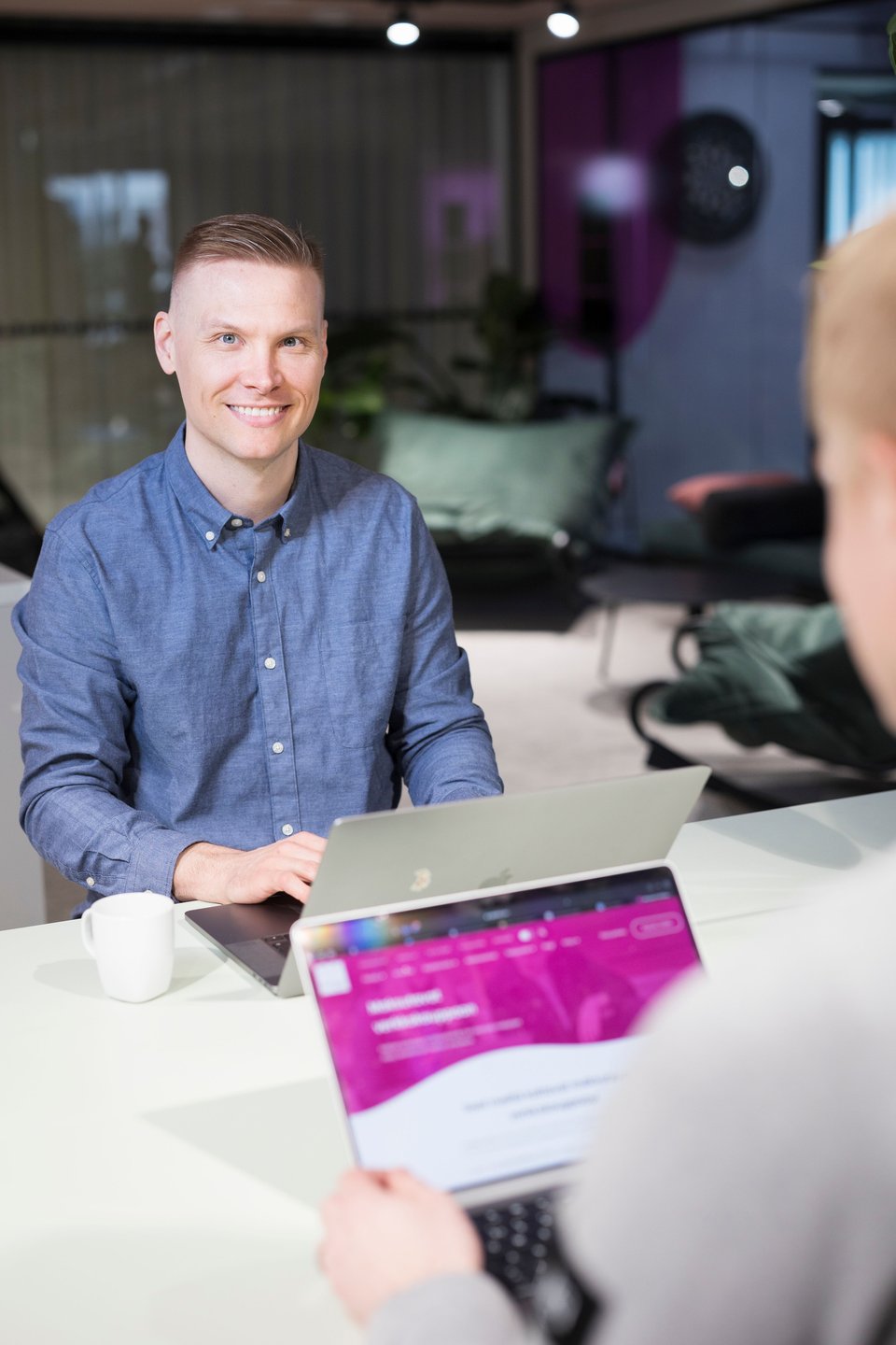 Person smiling during a discussion at the Paytrail office