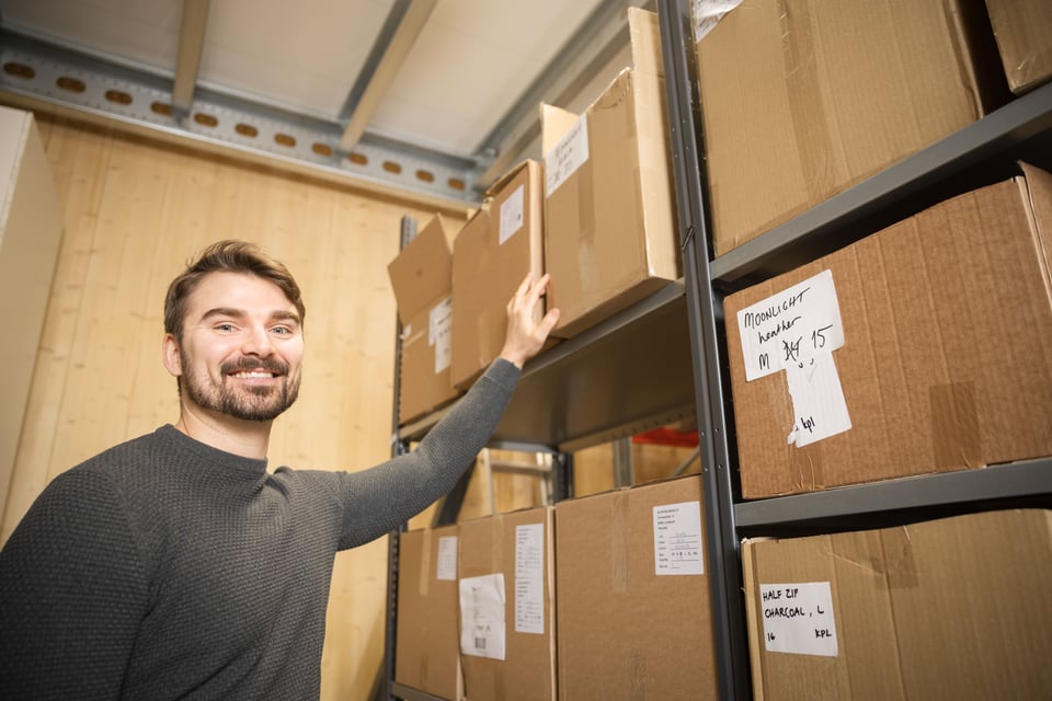 Man organizing boxes on a warehouse shelf