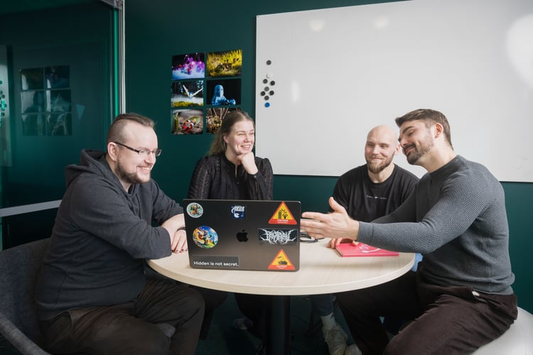 People working together at a round table with laptops