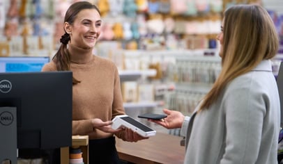 Nainen maksamassa maksupäätteellä